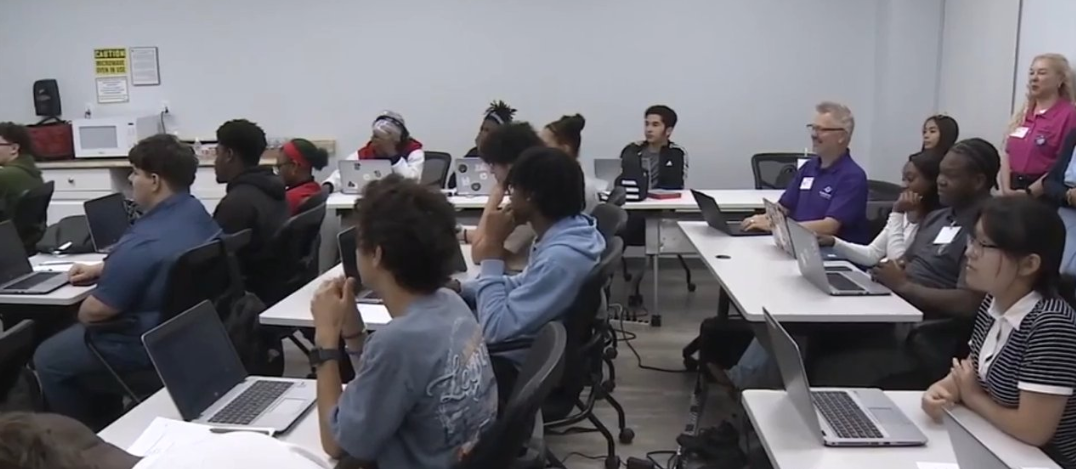 Students working on laptops in an AI classroom session