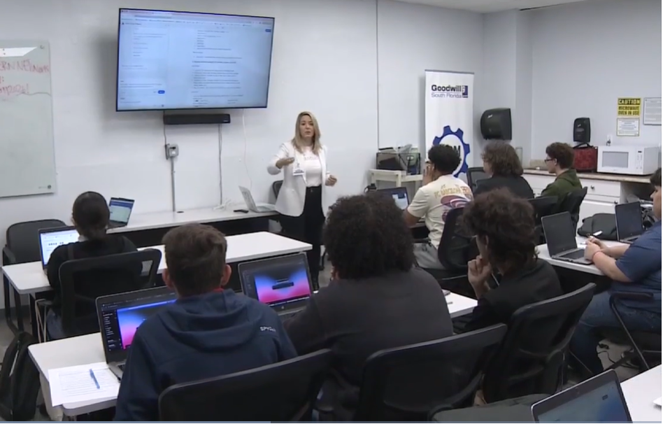 Instructor leading a cohort of students through a laptop training session